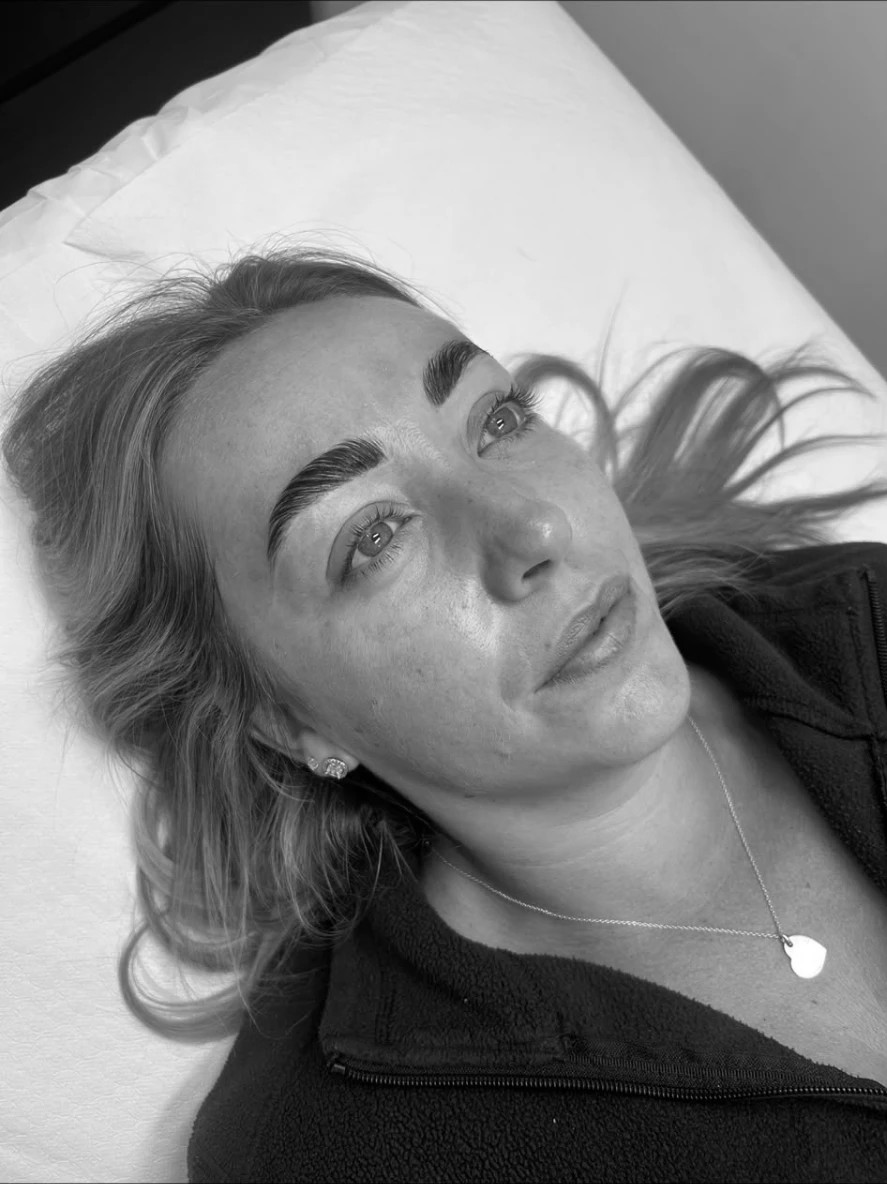 Client on the treatment bed showing newly laminated brows